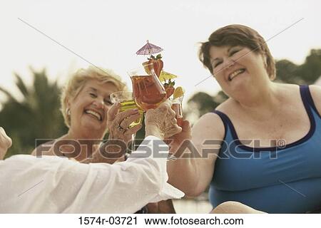 Three senior women toasting with cocktails View Large Photo Image Stock Image - Three senior women toasting with cocktails. Fotosearch