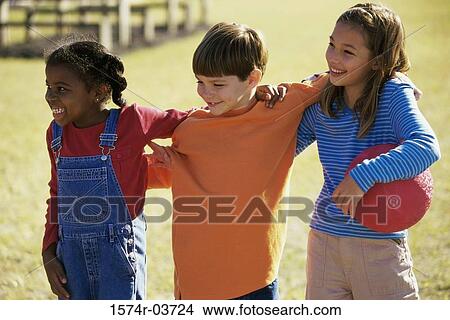 Two girls and a boy standing together View Large Photo Image Picture - Two girls and a boy standing together. Fotosearch
