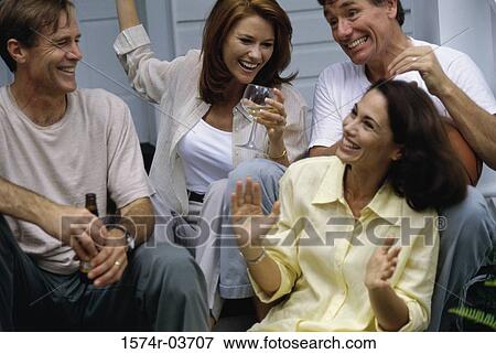 Two mid adult couples sitting on steps View Large Photo Image Stock Photo - Two mid adult couples sitting on steps. Fotosearch