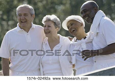 Stock Image - Two senior couples standing together. Fotosearch