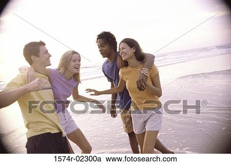 Two teenage couples on the beach View Large Photo Image Stock Image - Two teenage couples on the beach. Fotosearch
