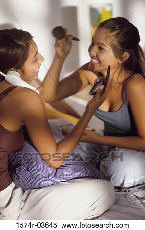 Two teenage girls playing and talking on the telephone View Large Photo Image Stock Photography - Two teenage girls playing and talking on the telephone. Fotosearch