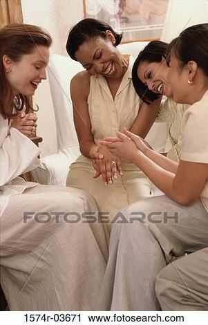 Young woman showing her engagement ring to her friends View Large Photo Image Stock Image - Young woman showing her engagement ring to her friends. Fotosearch
