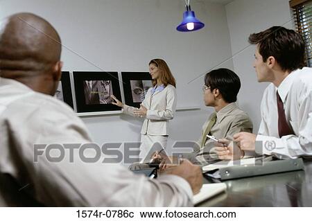 Business executives at a presentation in a conference room View Large Photo Image Stock Image - Business executives at a presentation in a conference room. Fotosearch