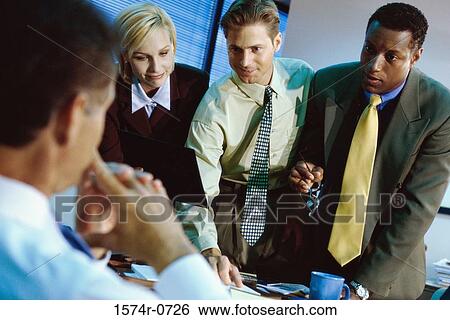 Business executives discussing in an office View Large Photo Image Stock Photograph - Business executives discussing in an office. Fotosearch