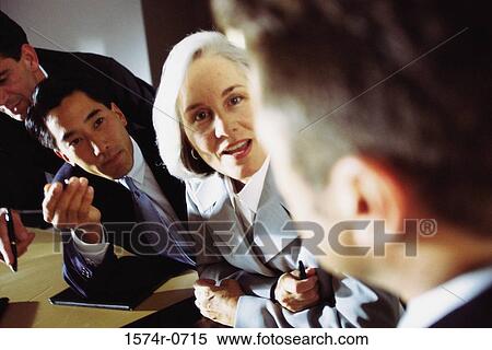 Stock Photography - Business executives discussing in an office. Fotosearch