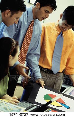 Stock Photo - Business executives having a discussion with a pie chart. Fotosearch