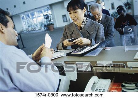 Business executives standing at a counter View Large Photo Image Stock Image - Business executives standing at a counter. Fotosearch