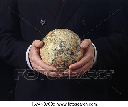 Stock Image - Businessman holding a globe. Fotosearch