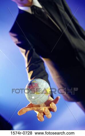 Stock Photo - Businessman holding a globe. Fotosearch