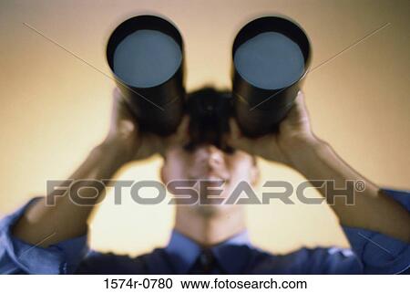 Stock Image - Businessman looking through a pair of binoculars. Fotosearch