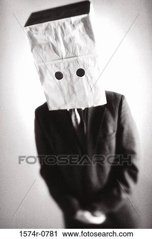 Stock Image - Businessman standing with a paper bag over his head. Fotosearch