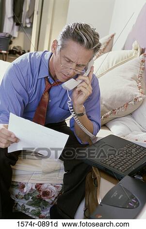 Stock Image - Businessman talking on a telephone. Fotosearch