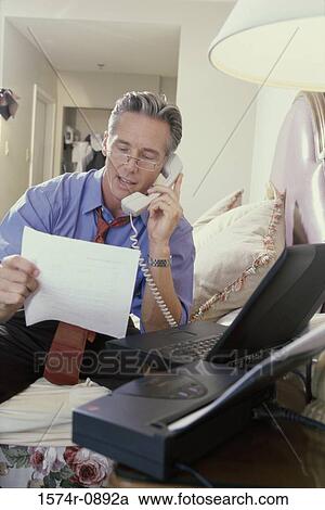 Stock Image - Businessman talking on a telephone. Fotosearch