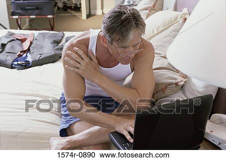 Stock Image - Businessman working on a laptop. Fotosearch