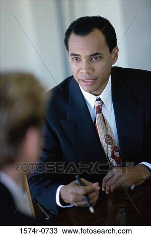Stock Image - Businessmen talking in a meeting. Fotosearch