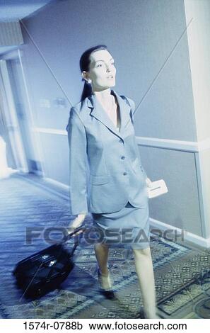 Businesswoman walking with a stroller in a corridor View Large Photo Image Stock Image - Businesswoman walking with a stroller in a corridor. Fotosearch