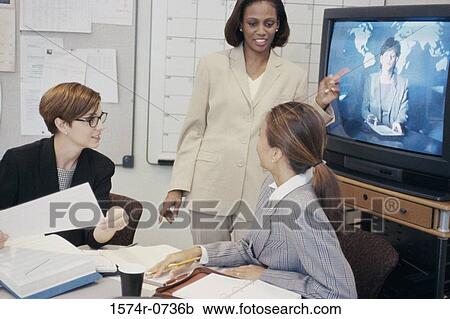 Businesswomen participating in a video conference View Large Photo Image Stock Image - Businesswomen participating in a video conference. Fotosearch