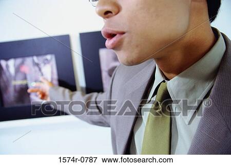 Stock Photo - Close-up of a businessman pointing. Fotosearch