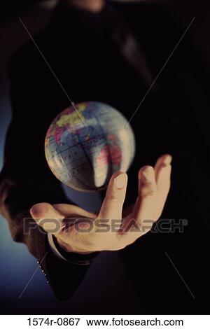 Close-up of a person's hand holding a globe View Large Photo Image Stock Photo - Close-up of a person's hand holding a globe. Fotosearch