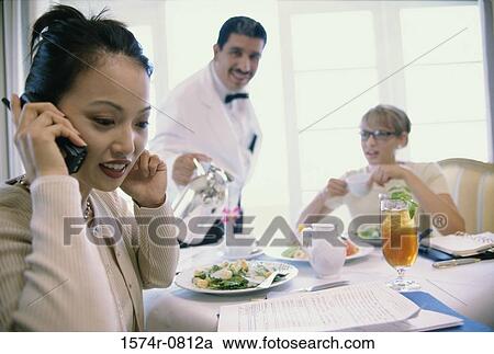 Close-up of a young businesswoman talking on a mobile phone View Large Photo Image Stock Image - Close-up of a young businesswoman talking on a mobile phone. Fotosearch