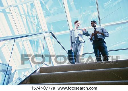 Low angle view of two business executives standing at the top of stairs View Large Photo Image Stock Image - Low angle view of two business executives standing at the top of stairs. Fotosearch