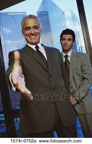 Portrait of a businessman holding his hand out View Large Photo Image Stock Image - Portrait of a businessman holding his hand out. Fotosearch