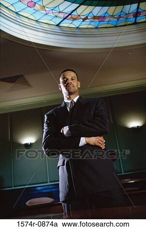 Portrait of a businessman standing with his arms folded View Large Photo Image Stock Image - Portrait of a businessman standing with his arms folded. Fotosearch
