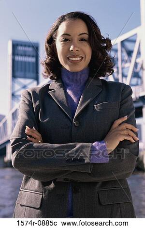 Stock Image - Portrait of a young businesswoman with her arms folded. Fotosearch