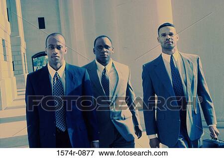 Portrait of three businessmen walking together View Large Photo Image Stock Photo - Portrait of three businessmen walking together. Fotosearch