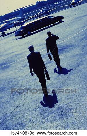 Stock Image - Rear view of two businessmen. Fotosearch