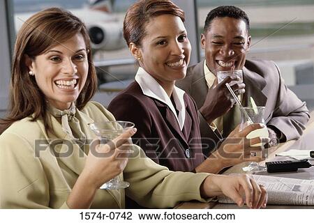 Stock Image - Three business executives holding glasses. Fotosearch