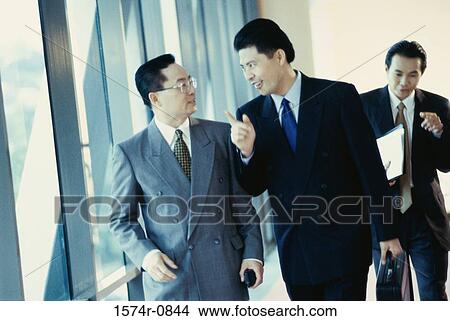 Three businessmen discussing View Large Photo Image Picture - Three businessmen discussing. Fotosearch