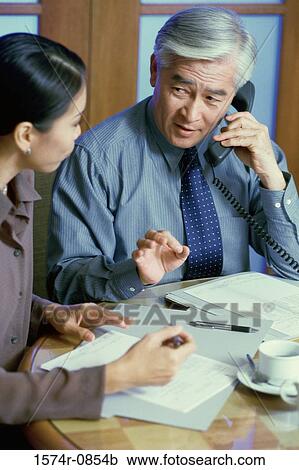 Stock Image - Two business executives having a discussion. Fotosearch