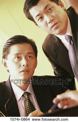 Two businessmen sitting and listening View Large Photo Image Picture - Two businessmen sitting and listening. Fotosearch