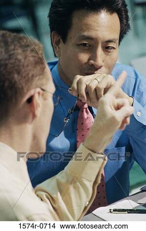 Two businessmen sitting and talking View Large Photo Image Picture - Two businessmen sitting and talking. Fotosearch