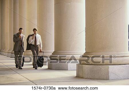 Stock Image - Two businessmen walking. Fotosearch