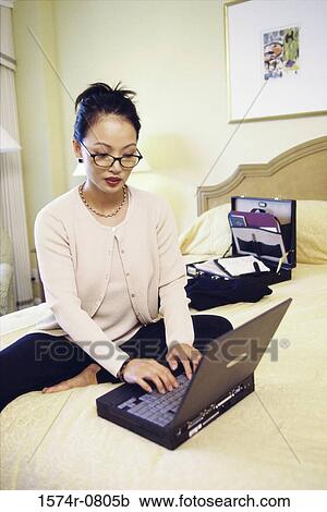 Young businesswoman operating a laptop View Large Photo Image Stock Image - Young businesswoman operating a laptop. Fotosearch