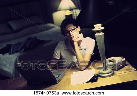 Stock Image - Young businesswoman using a laptop. Fotosearch