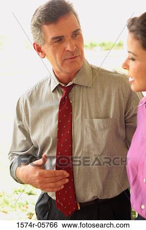 Businessman and a businesswoman talking View Large Photo Image Stock Photograph - Businessman and a businesswoman talking. Fotosearch