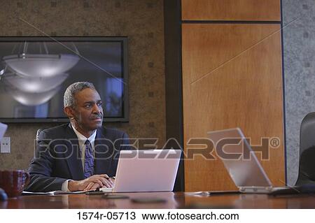 Businessman sitting in a conference room View Large Photo Image Stock Image - Businessman sitting in a conference room. Fotosearch