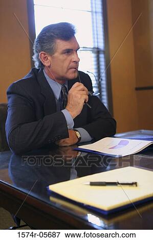 Businessman sitting in an office View Large Photo Image Stock Photo - Businessman sitting in an office. Fotosearch