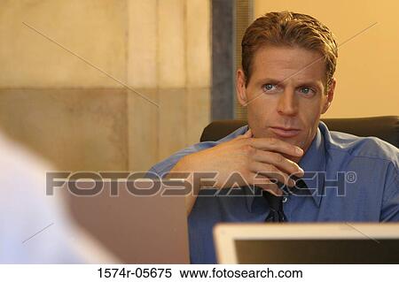Businessman sitting in an office View Large Photo Image Stock Photography - Businessman sitting in an office. Fotosearch