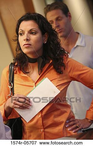 Businessman standing behind a businesswoman View Large Photo Image Stock Photo - Businessman standing behind a businesswoman. Fotosearch