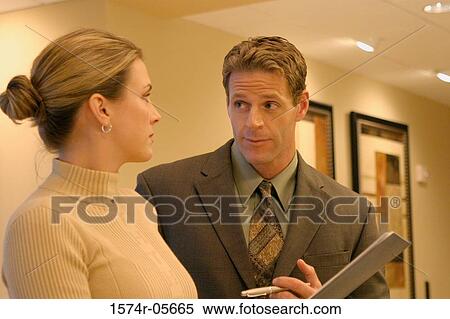 Businessman talking to a businesswoman View Large Photo Image Stock Photography - Businessman talking to a businesswoman. Fotosearch