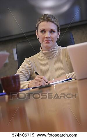 Businesswoman sitting in an conference room View Large Photo Image Stock Photo - Businesswoman sitting in an conference room. Fotosearch