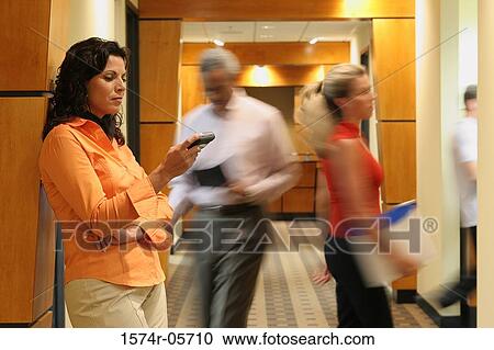 Businesswoman using a mobile phone View Large Photo Image Stock Image - Businesswoman using a mobile phone. Fotosearch