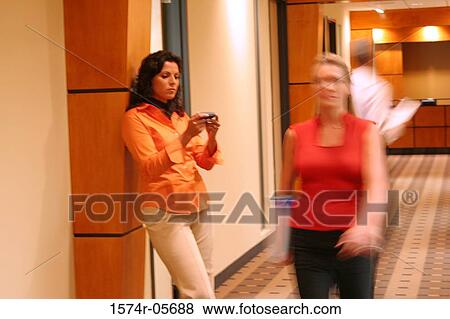 Stock Photo - Businesswoman walking in a corridor. Fotosearch