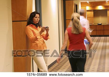 Stock Photo - Businesswoman walking in a corridor. Fotosearch