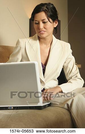 Businesswoman working on a laptop View Large Photo Image Stock Image - Businesswoman working on a laptop. Fotosearch